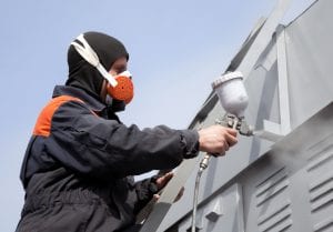 Man with spray gun re-painting Commercial building Sydney